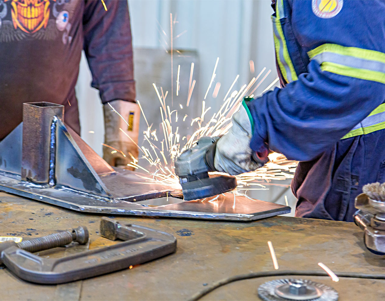Two Men's Hands Welding With Sparks