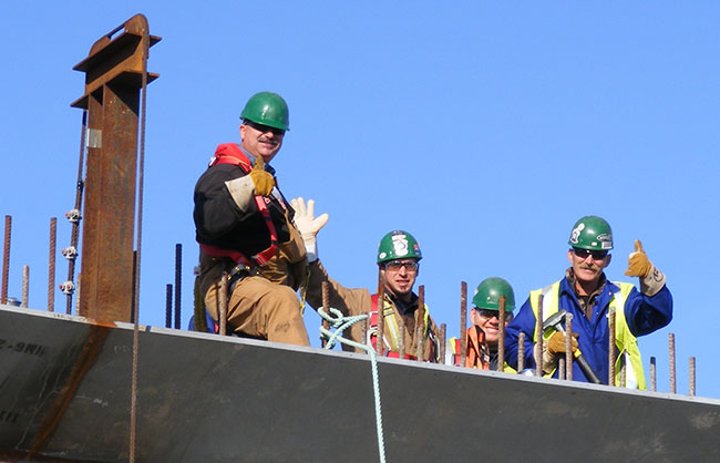 Lorneville Tradespeople Waving from Roof